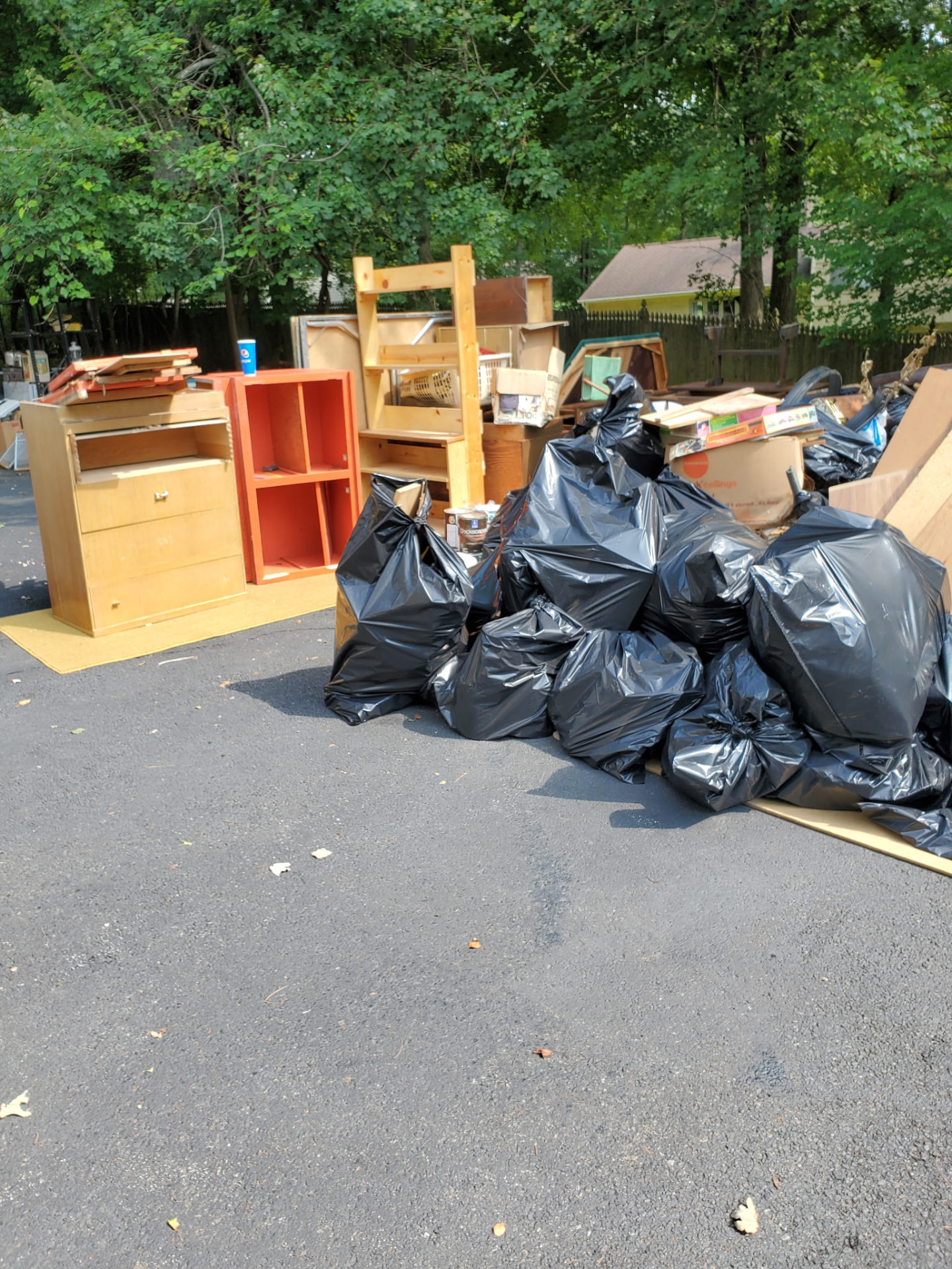 Attic packed with boxes and stored clutter before an attic cleanout in New Jersey