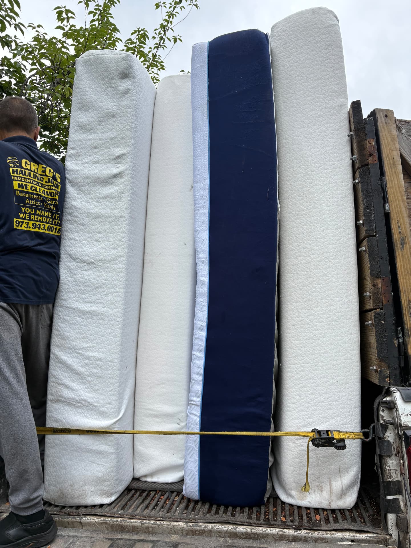 Old mattresses and box springs set out for mattress removal in New Jersey
